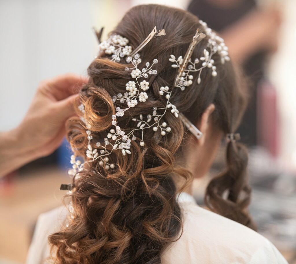 woman in white shirt with brown and white floral hair tie